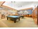 Billiard room with two pool tables, wall art and ample seating in a recreational space at 482 Bonnie Brook Pl, Henderson, NV 89012