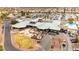 An aerial view of the clubhouse and amenities including parking, patio area, golf carts, and desert landscaping at 482 Bonnie Brook Pl, Henderson, NV 89012