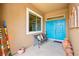 Inviting entryway with a colorful front door, bench seating, and decorative accents at 482 Bonnie Brook Pl, Henderson, NV 89012