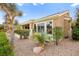 Exterior view of the property featuring desert landscaping with rocks, trees and well maintained shrubs at 482 Bonnie Brook Pl, Henderson, NV 89012