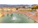 The community offers a golf course with a pond and fountain, set in picturesque desert landscape at 482 Bonnie Brook Pl, Henderson, NV 89012