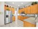 Bright kitchen features stainless steel appliances, ample counter space, and wood cabinetry at 482 Bonnie Brook Pl, Henderson, NV 89012