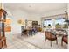 Spacious living room with tile and carpet flooring, dining area, and bright natural light at 482 Bonnie Brook Pl, Henderson, NV 89012