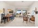 Bright living room with dining area featuring a large window and comfortable seating arrangement at 482 Bonnie Brook Pl, Henderson, NV 89012