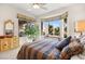 Cozy bedroom featuring bay window with great views of the lush garden at 482 Bonnie Brook Pl, Henderson, NV 89012