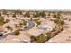 An aerial view of a quiet neighborhood, with mature trees, desert landscaping, and tile roofs at 482 Bonnie Brook Pl, Henderson, NV 89012