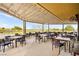 Expansive outdoor patio with comfortable seating, perfect for dining with serene golf course views at 482 Bonnie Brook Pl, Henderson, NV 89012