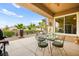 Outdoor patio with desert landscaping, glass table and chairs, and a built-in ceiling fan at 482 Bonnie Brook Pl, Henderson, NV 89012