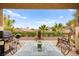 Outdoor patio featuring a barbecue grill, glass-topped table, and desert landscaping at 482 Bonnie Brook Pl, Henderson, NV 89012