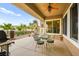 Outdoor patio with desert landscaping, glass table and chairs, and a built-in ceiling fan at 482 Bonnie Brook Pl, Henderson, NV 89012