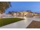 This backyard features a pool, lush green lawn, and patio with ample seating, perfect for outdoor entertaining at 4842 Plata Del Sol Dr, Las Vegas, NV 89121