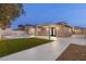 A spacious backyard showcasing a covered patio, swimming pool, and artificial turf at 4842 Plata Del Sol Dr, Las Vegas, NV 89121