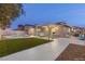 This backyard features a pool, lush green lawn, and patio with ample seating, perfect for outdoor entertaining at 4842 Plata Del Sol Dr, Las Vegas, NV 89121