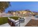 Inviting backyard with a pool, fire pit, and outdoor living space with covered patio, perfect for entertaining at 4842 Plata Del Sol Dr, Las Vegas, NV 89121