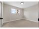 This bedroom includes carpet floors and window letting in lots of natural light with a view of a palm tree at 4842 Plata Del Sol Dr, Las Vegas, NV 89121