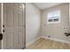 Laundry room boasts wood-look floors, natural light, and washer/dryer hookups for convenience at 4842 Plata Del Sol Dr, Las Vegas, NV 89121