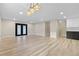 Spacious living room features modern flooring, stylish lighting, and access to an outdoor area at 4842 Plata Del Sol Dr, Las Vegas, NV 89121