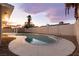 Backyard features a sparkling private pool, surrounded by a concrete deck and secure block fencing at 4842 Plata Del Sol Dr, Las Vegas, NV 89121