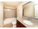 Well-lit bathroom featuring a tub-shower, toilet, and sink with granite counters at 5000 Indian River Dr # 475, Las Vegas, NV 89103