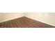 Corner view of a bedroom featuring wood-look floors and neutral wall paint at 5000 Indian River Dr # 475, Las Vegas, NV 89103