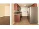 Kitchen with stainless appliances, tiled floor, and wooden cabinets, open to living room at 5000 Indian River Dr # 475, Las Vegas, NV 89103