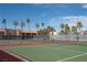 Full shot of a tennis court in a condominium complex with palm trees in the background at 5000 Indian River Dr # 475, Las Vegas, NV 89103