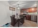 Cozy dining area with modern chandelier, dark wood cabinets and stainless steel appliances at 5180 Indian River Dr # 355, Las Vegas, NV 89103