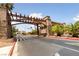 Welcoming community entrance features stone pillars, mature palm trees and lush landscaping at 5180 Indian River Dr # 355, Las Vegas, NV 89103