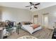 Bright main bedroom with ceiling fan, desk and bathroom access on stylish modern floors at 5588 Holcomb Bridge Ct, Las Vegas, NV 89149