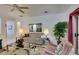 Bright living room featuring tile floors, beige sofa, and lots of windows at 563 Cypress Gardens Pl, Henderson, NV 89012