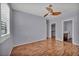 A bedroom offers wood floors, a ceiling fan and a walk-in closet at 576 Bayo Canyon Ct, Henderson, NV 89015