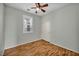 Bedroom with wood floors, sliding closet, and window with shuttered blinds at 576 Bayo Canyon Ct, Henderson, NV 89015