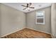 Cozy bedroom features ceiling fan and window with shuttered blinds at 576 Bayo Canyon Ct, Henderson, NV 89015