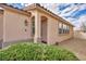 Charming home entrance with an arched doorway and well-maintained landscaping at 576 Bayo Canyon Ct, Henderson, NV 89015