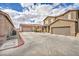 View of the property featuring a two-car garage and driveway in a residential neighborhood at 576 Bayo Canyon Ct, Henderson, NV 89015
