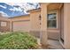 Exterior view of the home showcasing a two-car garage and covered entryway with a well-manicured lawn at 576 Bayo Canyon Ct, Henderson, NV 89015