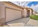 Close up exterior view of the 2 car garage and covered front entryway with well maintained landscaping at 576 Bayo Canyon Ct, Henderson, NV 89015