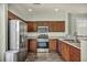 This kitchen boasts stainless steel appliances, granite counters, and dark wood cabinetry at 576 Bayo Canyon Ct, Henderson, NV 89015