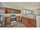 The well-equipped kitchen features stainless steel appliances, wood cabinets, and granite countertops at 576 Bayo Canyon Ct, Henderson, NV 89015