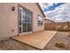 Backyard patio featuring concrete, rock landscaping and sliding glass door to the home at 576 Bayo Canyon Ct, Henderson, NV 89015