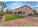 Expansive backyard featuring artificial grass, brick pavers, and a covered patio with an outdoor bar at 6214 Ebony Legends Ave, Las Vegas, NV 89131