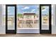 View of backyard through French doors with swimming pool, landscaping, and solar panels on the roof at 6214 Ebony Legends Ave, Las Vegas, NV 89131