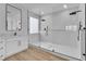 Modern bathroom showcases an expansive glass shower, white marble tiles, and sleek black fixtures at 6214 Ebony Legends Ave, Las Vegas, NV 89131