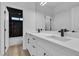 Modern bathroom with dual vanity, black fixtures, and marble shower at 6214 Ebony Legends Ave, Las Vegas, NV 89131