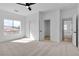 Bedroom featuring large window, closet doors, and connecting doors to other rooms at 6214 Ebony Legends Ave, Las Vegas, NV 89131