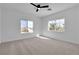 Bright bedroom with a ceiling fan and two windows offering neighborhood views at 6214 Ebony Legends Ave, Las Vegas, NV 89131
