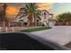 Elegant two-story home with a spacious driveway, well-manicured landscaping, and attached two car garage at 6214 Ebony Legends Ave, Las Vegas, NV 89131