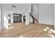 Elegant living room with modern lighting, wine storage, staircase, and bright wood floors at 6214 Ebony Legends Ave, Las Vegas, NV 89131