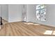 Bright, open living room featuring high ceilings, large windows, and wood floors with elegant stairway at 6214 Ebony Legends Ave, Las Vegas, NV 89131