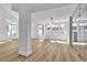 Bright, airy living room featuring hardwood floors, modern lighting, and large windows at 6214 Ebony Legends Ave, Las Vegas, NV 89131